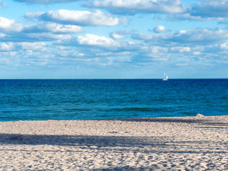 Blue Water and cloudy skies at the beachの写真素材