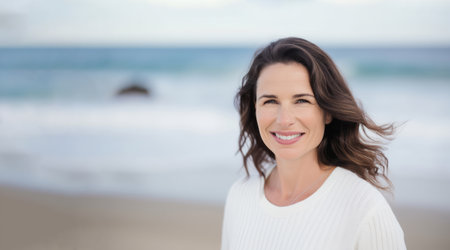 Joyful 30-year-old woman with sun-kissed hair on a serene beach backdrop
