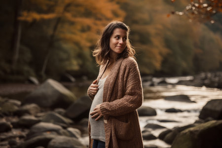 Beautiful pregnant woman in the autumn forest. Pregnancy concept.の素材