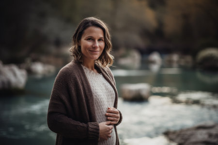 Portrait of a beautiful woman on the background of a mountain riverの素材