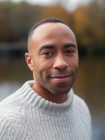 Portrait of handsome african american man in autumn park.の素材