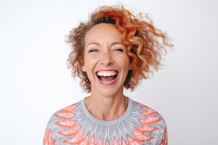 Close up portrait of a happy young woman laughing and looking at camera over white backgroundの素材