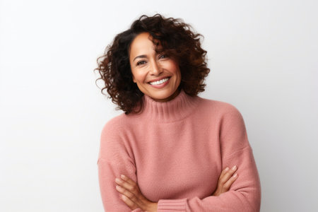 Portrait of a smiling middle-aged woman with curly hair isolated over white backgroundの素材