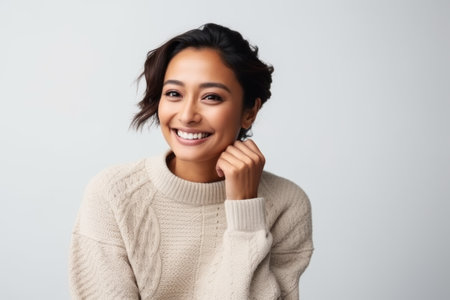 Portrait of a smiling young asian woman isolated on a white backgroundの素材