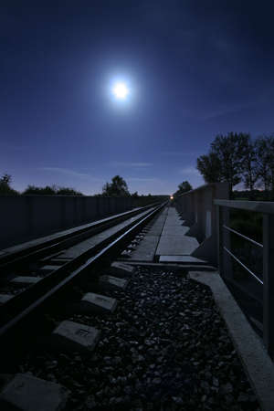 long railway in the light of the full moonの写真素材