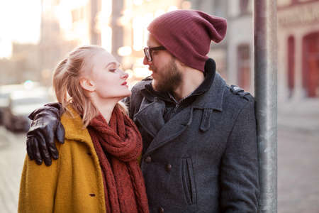 Young smiling happy hipster couple hugging in winterの写真素材