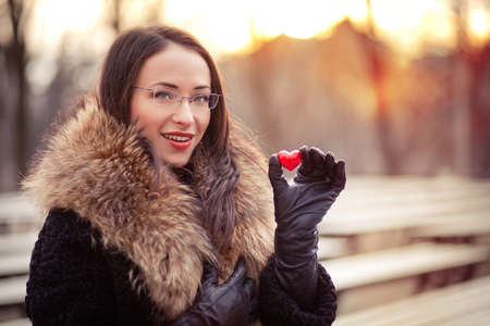 Pretty woman holding red heart on Valentines dayの写真素材