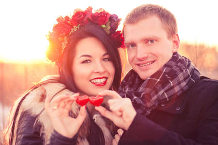 Young couple are holding pair of hearts as a symbol of their loveの写真素材