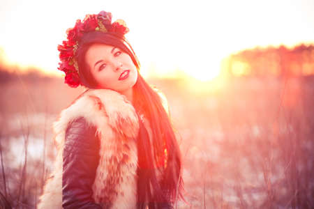Girl wearing flur vest in winter field lifestyle photo