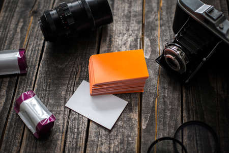 Template on a wooden pattern with old film camera and lens filtersの写真素材