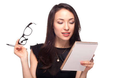 Sexy woman in glasses with notepad isolated on whiteの写真素材