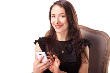 Woman is text messaging using cell phone isolated on whiteの写真素材