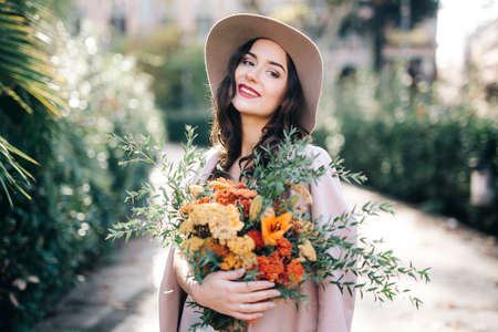 Fine art lifestyle Fashion model flowers in parkの写真素材