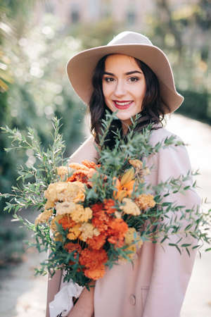 Fine art lifestyle Fashion model flowers in parkの写真素材