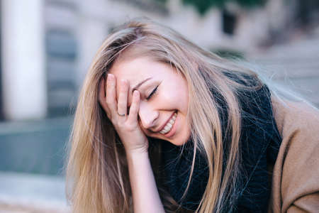 Blonde young woman smiling laughing fashion emotionalの写真素材