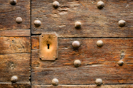 Ancient Italian door in Tuscany. Keyhole useful for concepts.の写真素材