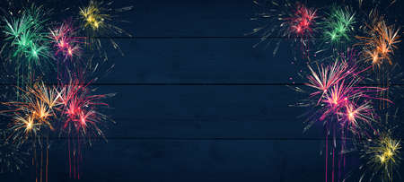 Silvester firework New Year background banner panorama - Colorful festive firework on rustic dark...