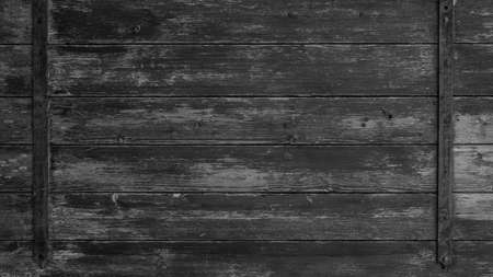 old abstract black gray gray peeled off rustic wooden boards / wooden gate / wooden door texture, with teel bolt - wood background shabbyの写真素材