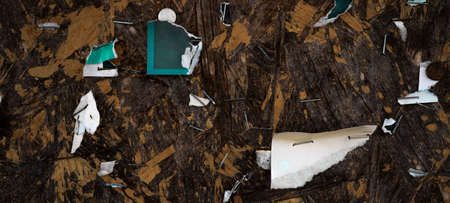 Old abstract dark dirty wooden advertisement billboard with staples and old torn paper posters...