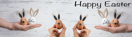 Happy Easter background banner panorama greeting card - Young women holding Easter eggs with bunny...