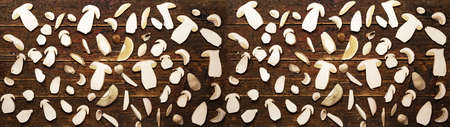Top view of sliced Boletus edulis (king bolete) mushroom in cross section on dark old rustic brown...