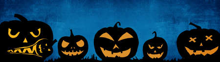 HALLOWEEN background banner wide panoramic panorama template -Silhouette of scary carved luminous cartoon pumpkins and isolated on dark blue textureの写真素材