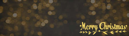 Merry Christmas festive celebration background banner panorama greeting card - Hand lettering, on golden texture, with abstract bokeh lightsの写真素材