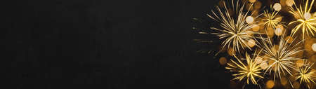 HAPPY NEW YEAR - Festive silvester background panorama greeting card  banner long - Golden firework and bokeh light in the dark black  nightの写真素材