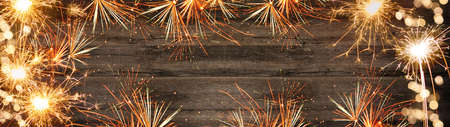 New Year's Eve, Silvester background panorama long - Firework on rustic brown wooden texture with...