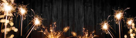 Silvester party New year Fireworks background banner panorama long- sparklers and bokeh lights on rustic wooden texture, with space for text, New Year's Eveの写真素材