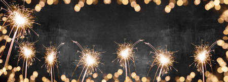 Silvester party New year Fireworks background banner panorama long- sparklers, fireworks and frame made of bokeh lights on rustic black texture, with space for text, New Year's Eveの写真素材