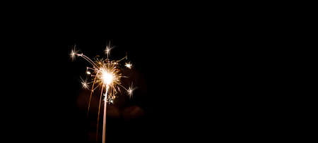 Silvester / New year background - Woman holds sparkling sparkler in her hand at dark night, New...