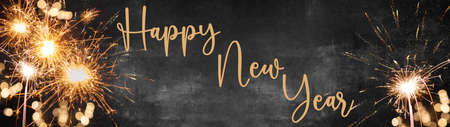 Happy New Year Party Fireworks background banner panorama - Abstract colorful firework or sparklers with yellow bokeh lights in the dark black night, New Year's Eveの写真素材