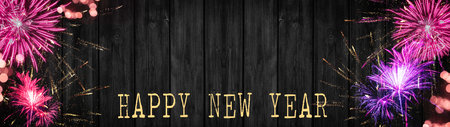 Silvester party New year Fireworks background banner panorama long- Firework and bokeh lights on rustic black wooden texture, with space for text, New Year's Eveの写真素材