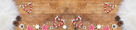 candy cane and cookies on sheepskin and rustic wooden table in modern kitchen - christmas background...