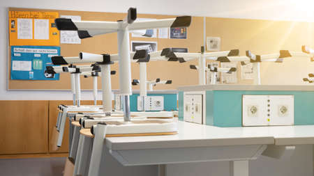 Empty physics room with high chairs and sockets on the tableの写真素材