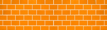 Orange abstract colored colorful brick tiles tilework glazed ceramic wall or floor texture wide background banner panorama patternの写真素材