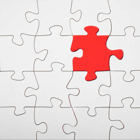 Empty white details of puzzle on red background square, with space for textの写真素材