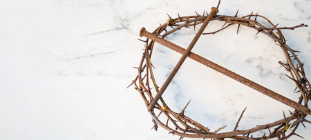 Crucifixion Of Jesus / religion easter background - Crown Of Thorns and rusty old nails in shape of a cross or crucifix, on white marble marble Ground or table or altarの写真素材