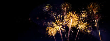 Fireworks pyrotechnics celebration party event festival holiday or New Year background panorama - Golden firework on dark night skyの写真素材