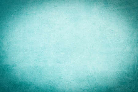 Abstract turquoise watercolor painted paper texture background, with dark vignetteの写真素材