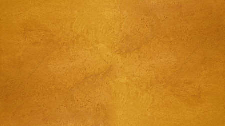 Abstract yellow golden marbled spotted stone wall texture backgroundの写真素材