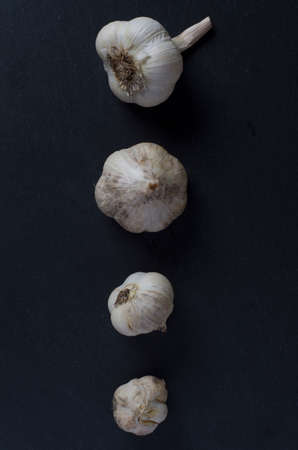 garlic on a black stone tableの写真素材