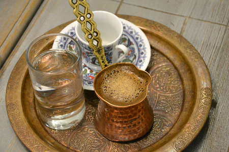 Traditional turkish coffee and a glass of waterの写真素材