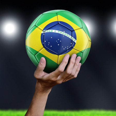Man holding Soccer ball with Brazilian flagの写真素材