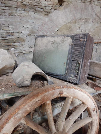 An old television set abandoned and covered in dustの写真素材