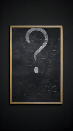 Question mark drawn on a blackboard with wooden frame and black background.の素材