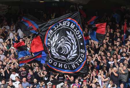 LONDON, ENGLAND - AUGUST 31, 2019: Palace ultras wave flags ahead of  the 2019/20 Premier League game between Crystal Palace FC and Aston Villa FC at Selhurst Park.のeditorial素材