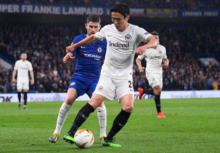 LONDON, ENGLAND - MAY 9, 2019: Jorge Luiz Frello Filho (Jorginho) of Chelsea (L) and Makoto Hasebe of Eintracht (R)pictured during the second leg of the 2018/19 UEFA Europa League Semi-Finals game between Chelsea FC (England) and Eintracht Frankfurt e.V. のeditorial素材
