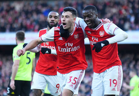 LONDON, ENGLAND - JANUARY 18, 2020: Gabriel Martinelli of Arsenal celebrates Nicolas Pepe of Arsenal after he scored a goal during the 2019/20 Premier League game between Arsenal FC and Sheffield United FC at Emirates Stadium.のeditorial素材
